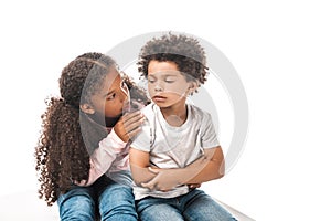 African american sister calming down upset brother isolated on white