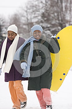 African American sisters and best friends laughing.