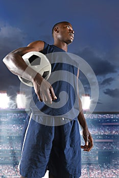 African American Soccer Player Holding Ball