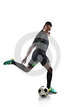 African American Soccer Player Kicking Ball