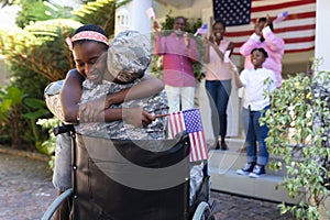 African american soldier father in wheelchair hugging daughter three generation family behind