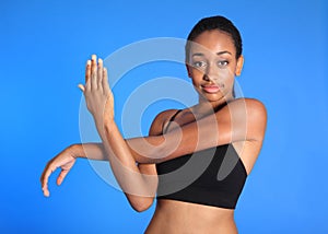 African American sports woman shoulder stretch