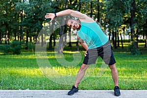 African american sportsman stretching in park