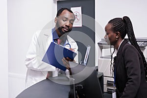 African american staff working on medical reports