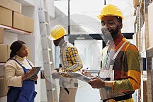 African american stock supply manager doing goods inventory portrait