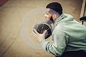 African-american streetball player resting outdoors