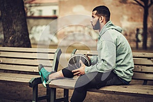 African-american streetball player resting outdoors