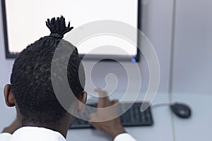 An african american IT student in the computer lab. Students listening lesson from his teacher