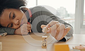 African American student doing activity playing block wooden for development together in the classroom