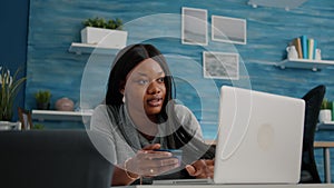 African american student holding cred card in hands doing online shopping searching store