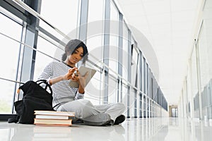 African american student with notebook in corridor in university