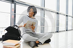 African american student with notebook in corridor in university