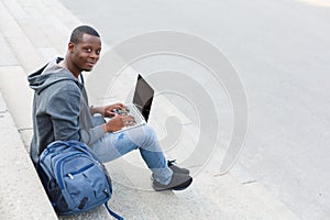 African-american student using digital tablet outdoors