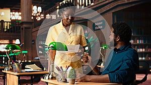 African American students reading their coursework in a quiet campus library