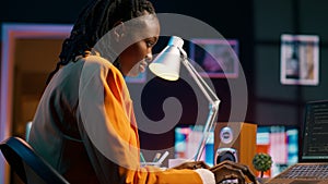 African american system engineer using AI system to write computer program code