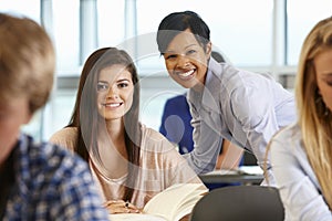 African American teacher helping student in class