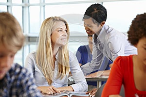 African American teacher helping student in class