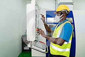 African American technician engineer operating milling cutting machine