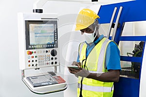 African American technician use tablet to control cutting machines