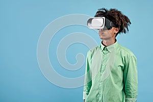 African american teen guy wearing VR headset, using virtual reality for entertainment, exploring cyberspace, free space