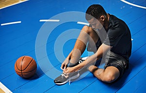 African American teenage boy tying his shoe laces