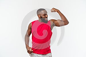 African American teenager shows muscles on arm. Isolated on white background. Studio portrait. Transitional age concept