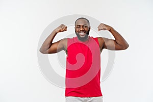 African American teenager shows muscles on arm. Isolated on white background. Studio portrait. Transitional age concept