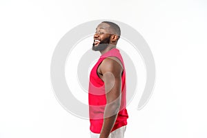 African American teenager shows muscles on arm. Isolated on white background. Studio portrait. Transitional age concept