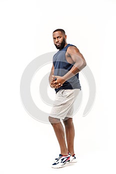 African American teenager shows muscles on arm. Isolated on white background. Studio portrait. Transitional age concept