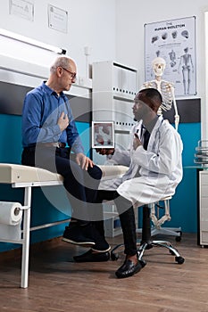 African american therapist doctor holding tablet computer with heart radiography