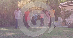 African american three generation family holding hands asking together in the garden