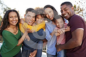 African American  three generation family playing together in the garden, smiling to camera