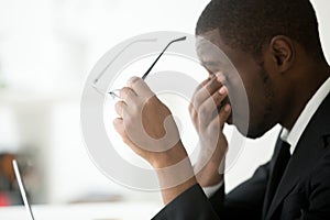 African american tired businessman feeling eyes fatigue taking o