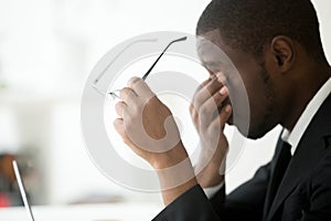 African american tired businessman feeling eyes fatigue taking o photo