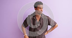 African american tired man touching forehead chin isolated on violet background