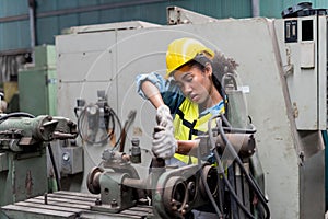 African American tired worker woman hard working sweat dirty gloves repair old machine in industrial manufacturing factory. black