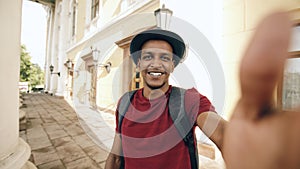 African american tourist man having online video chat using his smartphone camera while travelling in Europe