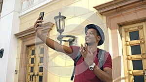 African american tourist man having online video chat using his smartphone camera while travelling in Europe