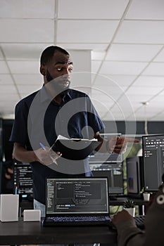 African american web developer analyzing html script on terminal window