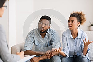 African American Wife Talking To Couple Counselor Sitting Next To Husband