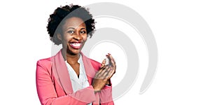 African american woman with afro hair wearing business jacket clapping and applauding happy and joyful, smiling proud hands