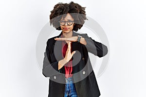 African american woman with afro hair wearing business jacket and glasses doing time out gesture with hands, frustrated and