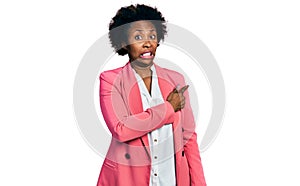 African american woman with afro hair wearing business jacket pointing aside worried and nervous with forefinger, concerned and
