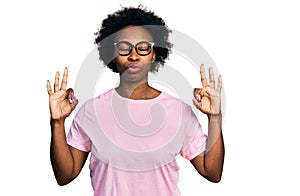 African american woman with afro hair wearing casual clothes and glasses relax and smiling with eyes closed doing meditation