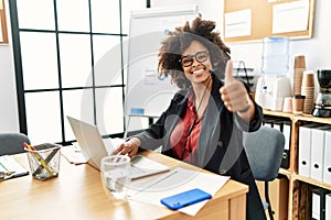 African american woman with afro hair working at the office wearing operator headset approving doing positive gesture with hand,