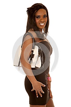 African American woman black dress purse on shoulder