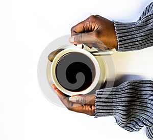 African American woman both hands holding a white cup of coffee. Black Female hands holding a hot cup of coffee with foam