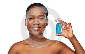 African american woman with bottle of serum