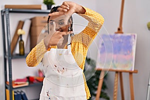 African american woman with braids at art studio smiling making frame with hands and fingers with happy face
