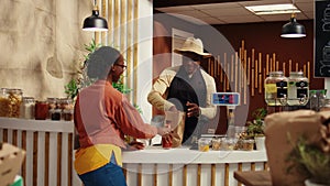 African american woman bringing natural products at checkout